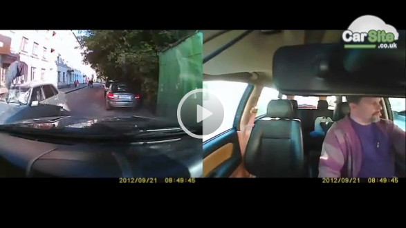 Man kicks moving car's windscreen